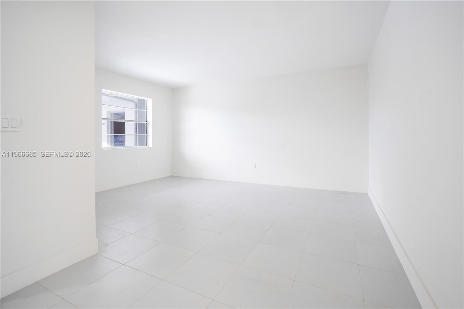 An empty room features white walls, light gray tile flooring, and a single window — 10375-35-55 SW 40th St # 0, Miami FL 33165, MIAMI, FL