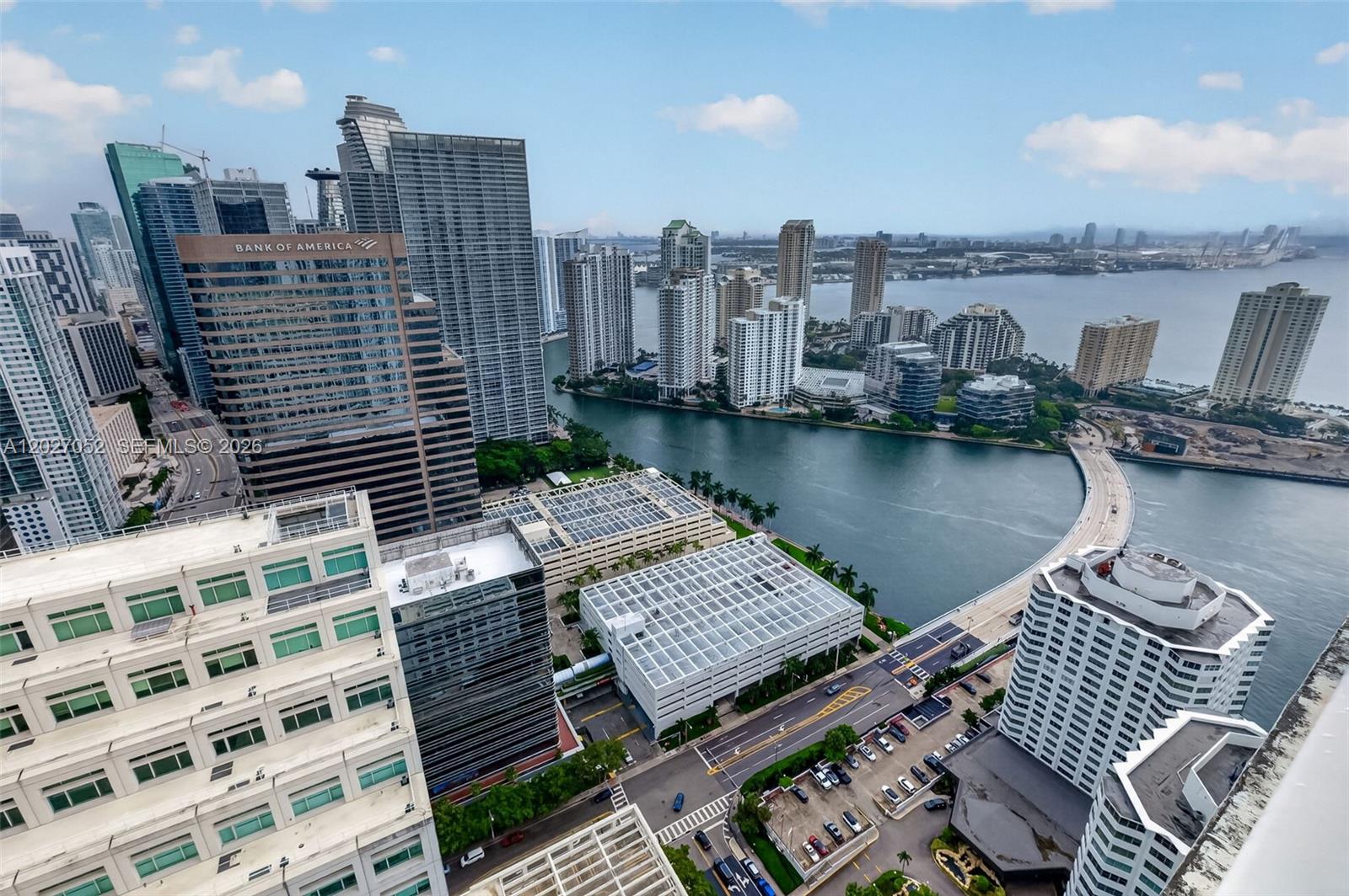 A living room features a sofa, coffee table, television, and a balcony with city views — 950 Brickell Bay Dr # 4504, Miami FL 33131, MIAMI, FL