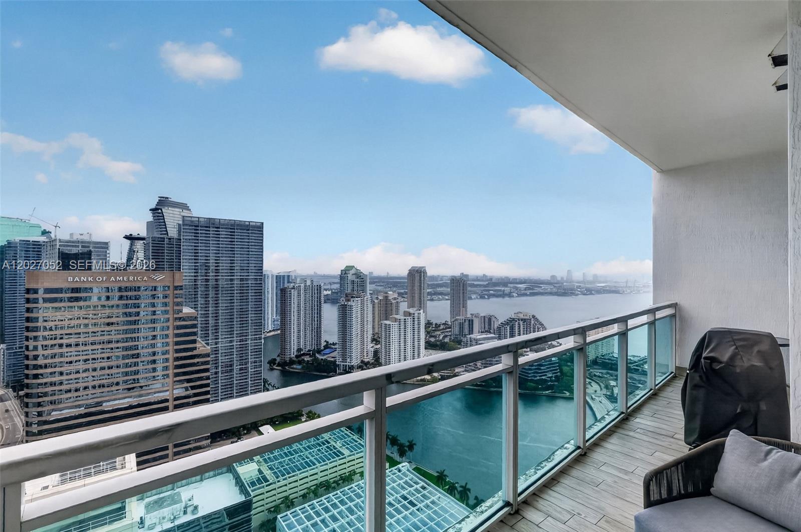 A kitchen features stainless steel appliances, granite countertops, and wood-look tile flooring — 950 Brickell Bay Dr # 4504, Miami FL 33131, MIAMI, FL