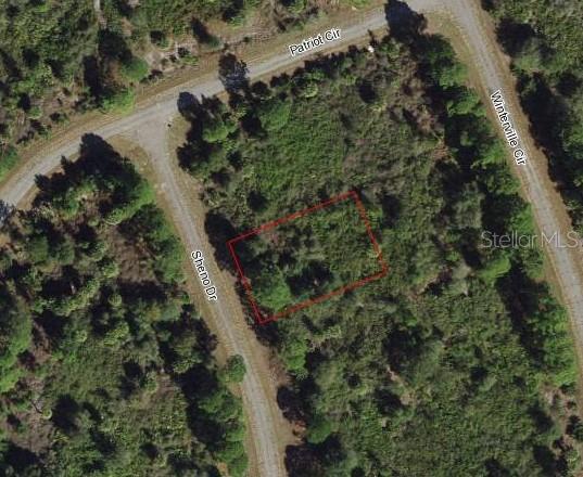 An aerial map view shows a vacant, rectangular lot outlined in red near paved roads — Lot 11 SHENO DRIVE, NORTH PORT, FL