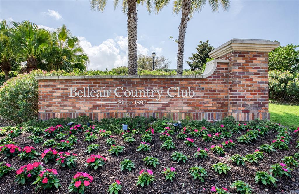 A brick sign for the Belleair Country Club sits behind a bed of pink flowers — 8 BELLEVIEW BOULEVARD UNIT 702, BELLEAIR, FL