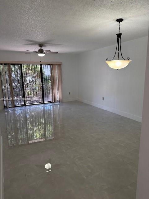 A bright living room features large sliding glass doors, a ceiling fan, and tile flooring — 5835 W 20th Ave # 106, Hialeah FL 33012, HIALEAH, FL