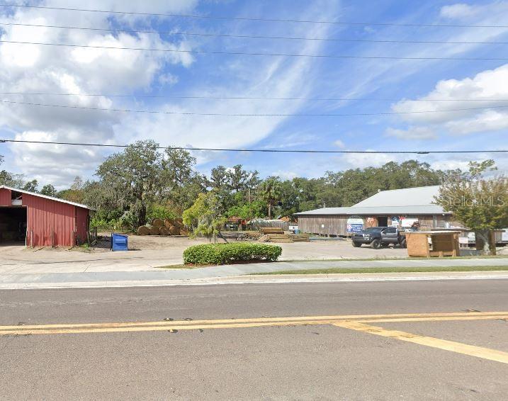 A view of a commercial property with a red barn, a warehouse, and a parking lot — N/A, POLK CITY, FL