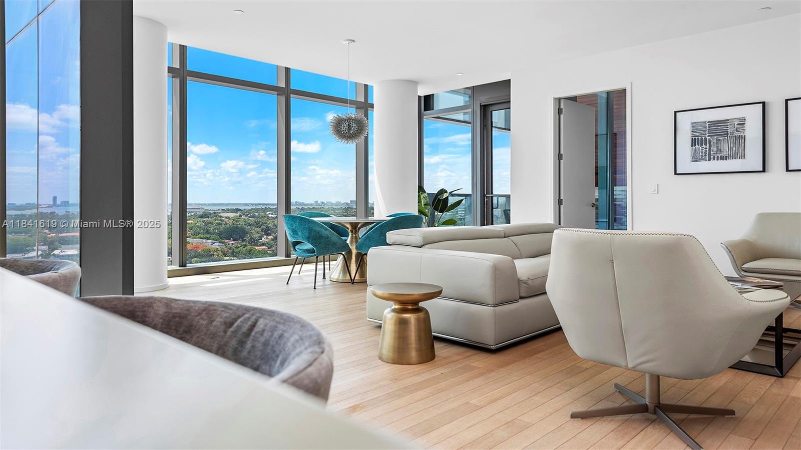 A modern living and dining area features floor-to-ceiling windows with expansive outdoor views — 2901 Collins Ave # 1403, Miami Beach FL 33140, MIAMI BEACH, FL