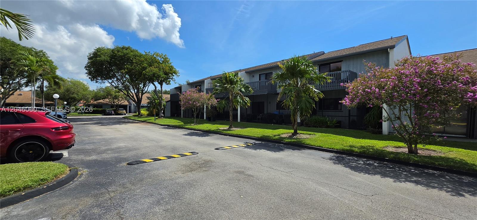 A two-story apartment building with balconies sits behind a parking lot with speed bumps — 1652 N 14th Ter # 1652, Hollywood FL 33020, HOLLYWOOD, FL