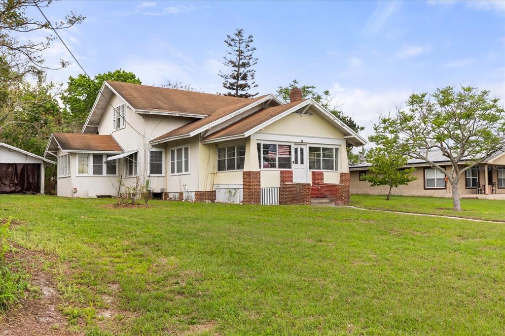 A two-story house with a front porch, brick accents, and a brown roof — 408 MCKAY DRIVE, HAINES CITY, FL