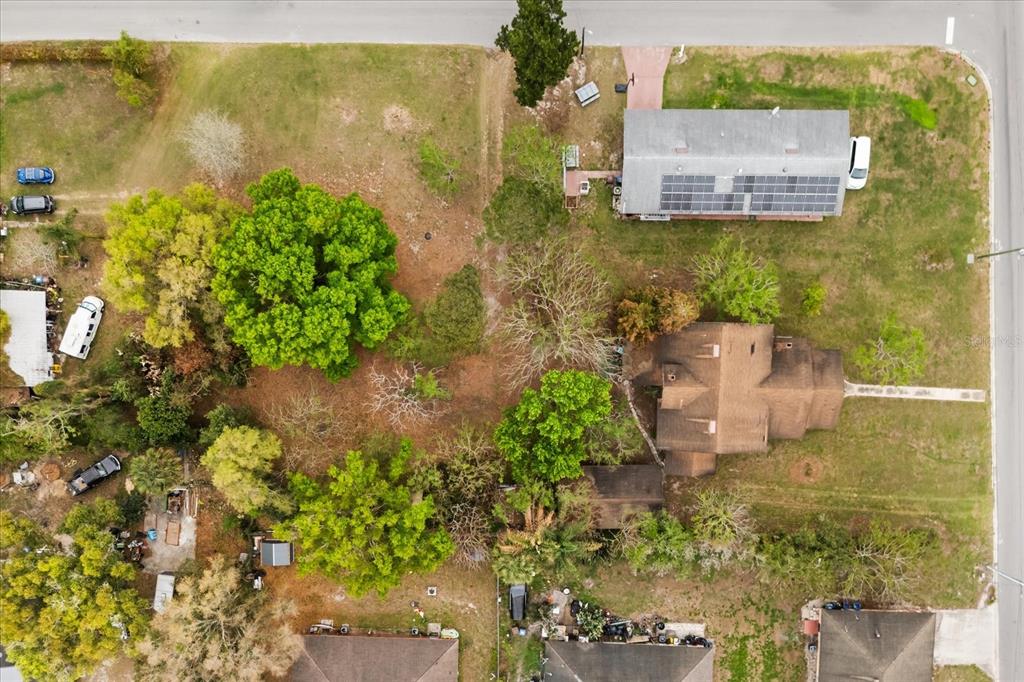 An aerial view shows a large residential lot with two houses, mature trees, and vehicles — 408 MCKAY DRIVE, HAINES CITY, FL