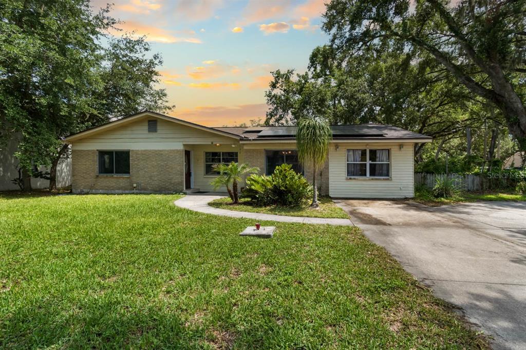 A single-story house with a brick and siding exterior, a driveway, and a front lawn — 201 MASON STREET, BRANDON, FL