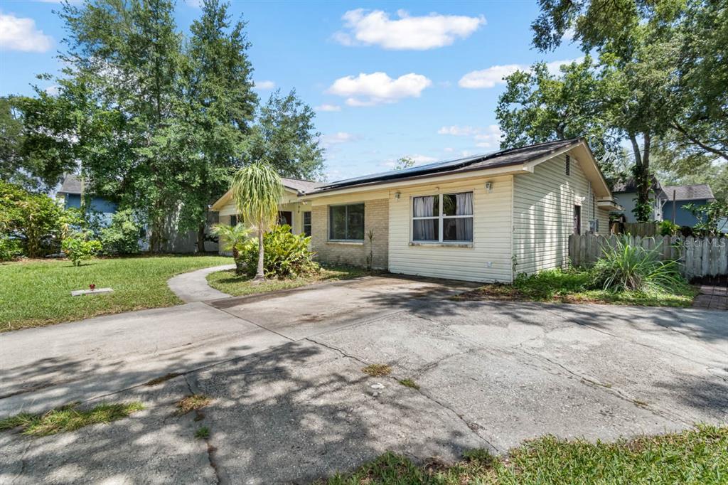 A single-story house with light-colored siding and a concrete driveway under a blue sky — 201 MASON STREET, BRANDON, FL