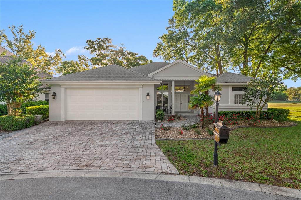 A single-story house with a paved driveway, a two-car garage, and a covered front entrance — 10801 SW 71ST AVE, OCALA, FL