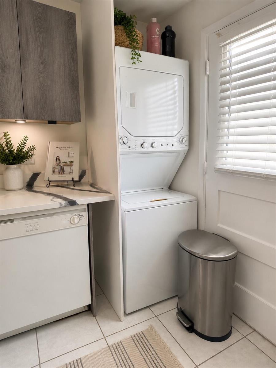 A laundry room features a stacked washer and dryer, a dishwasher, and a trash can — 5961 NW 2nd Avenue # 108, Boca Raton FL 33487, BOCA RATON, FL