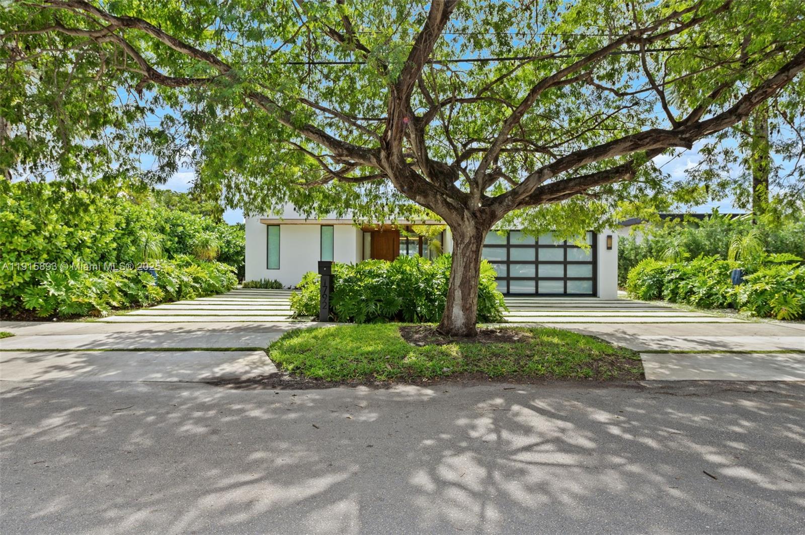 A modern white house with a large tree in the front yard and driveway — 1792 Cleveland Rd, Miami Beach FL 33141, MIAMI BEACH, FL