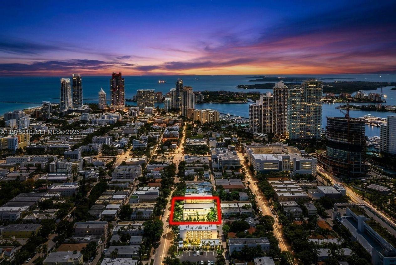 An aerial view of a city at dusk with a red box highlighting a building — 1000 7th St, Miami Beach FL 33139, MIAMI BEACH, FL