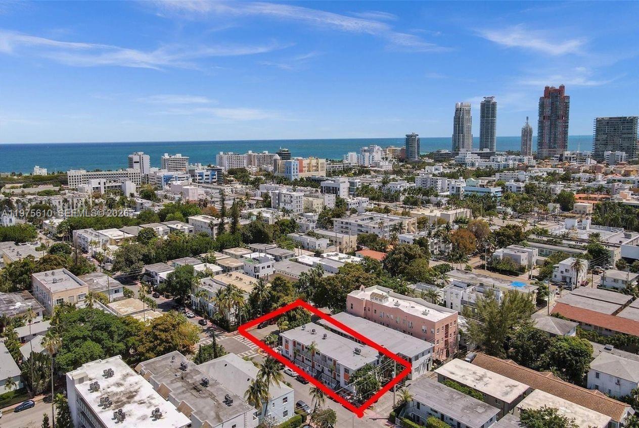 An aerial view shows a multi-story apartment building outlined in red within a coastal city — 1000 7th St, Miami Beach FL 33139, MIAMI BEACH, FL