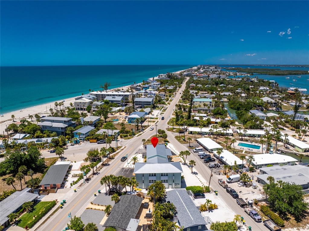 An aerial view shows a coastal town with a multi-story building marked by a pin — 1285 GULF BOULEVARD UNIT 4, ENGLEWOOD, FL