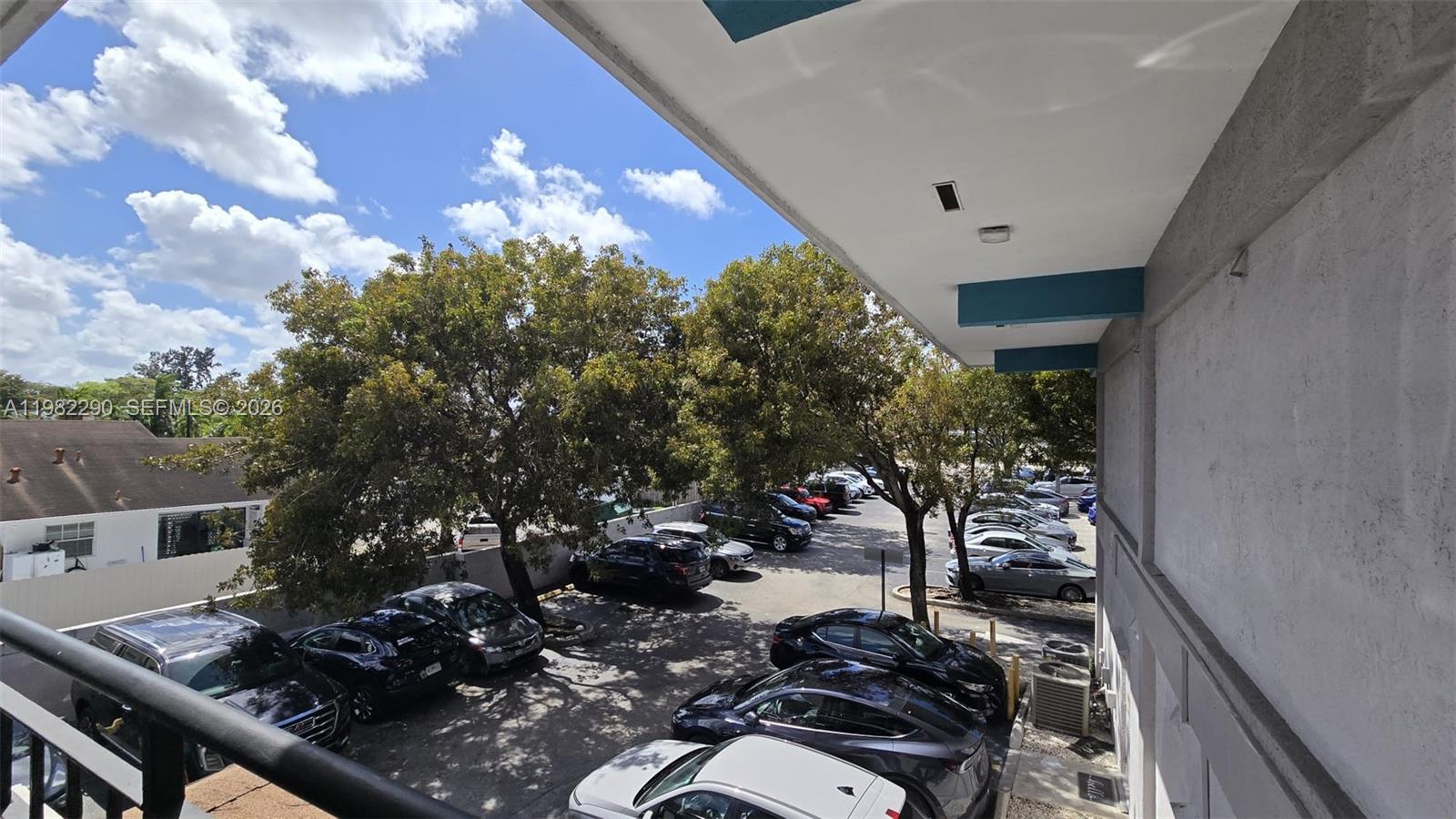 An elevated view looks down onto a parking lot filled with cars near trees — 957 SW 122nd Ave # 957, Miami FL 33184, MIAMI, FL