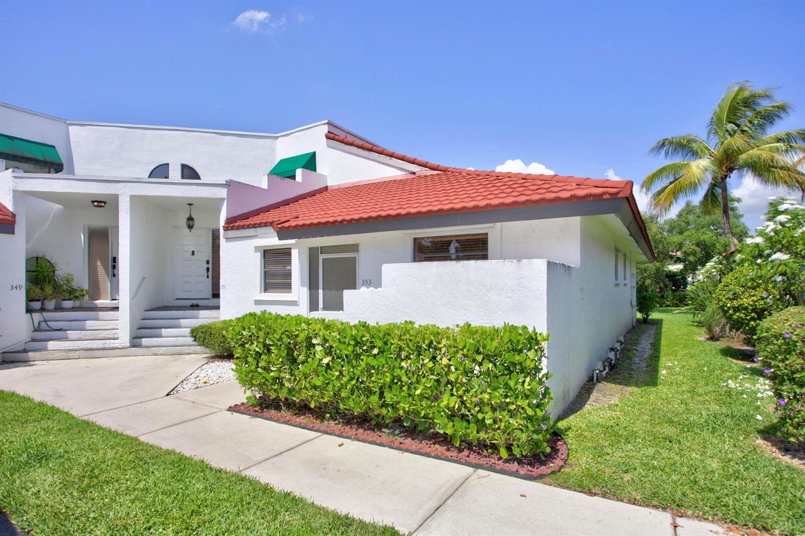 A white stucco townhouse with a red tile roof and a green hedge in front — 353 NW 36th Avenue, Deerfield Beach FL 33442, DEERFIELD BEACH, FL