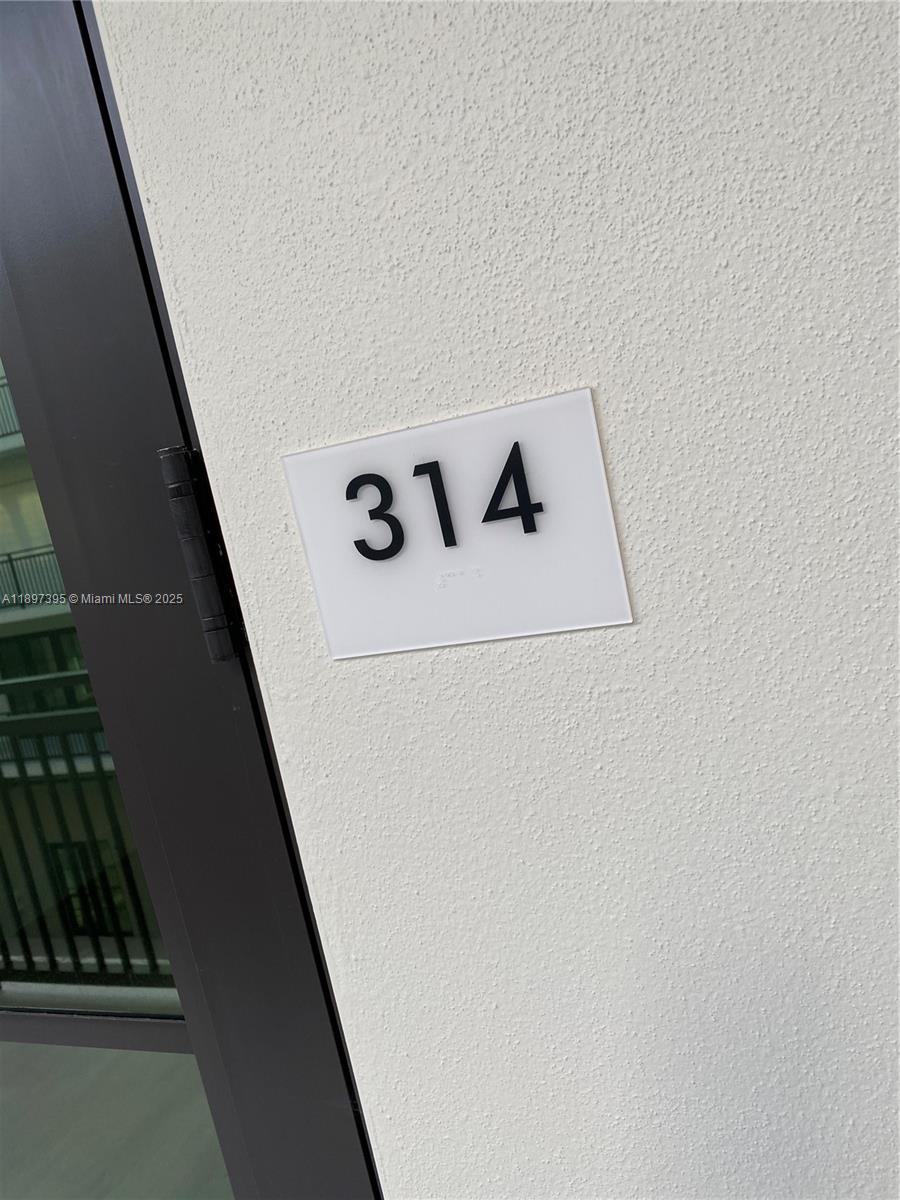 A white wall features a rectangular sign displaying the number 314 next to a door — 4100 SW 64th Ave # 314, Davie FL 33314, DAVIE, FL