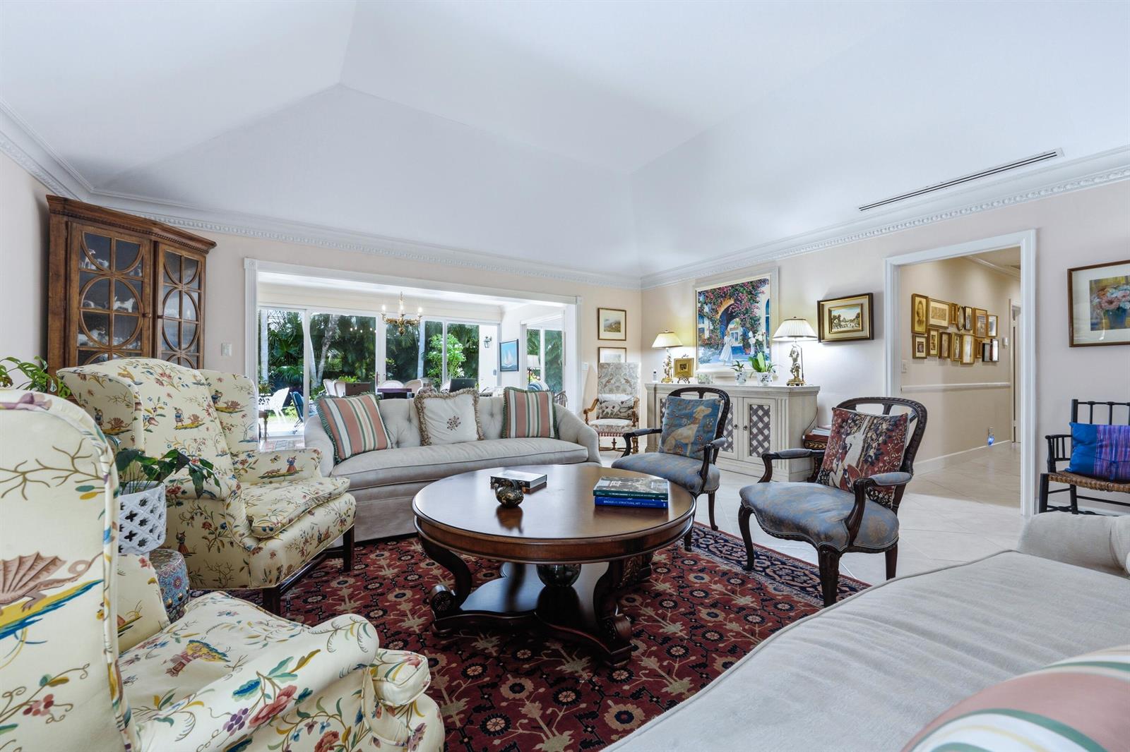 A living room features a vaulted ceiling, a large area rug, and traditional furniture — 265 Fairview Road, Palm Beach FL 33480, PALM BEACH, FL