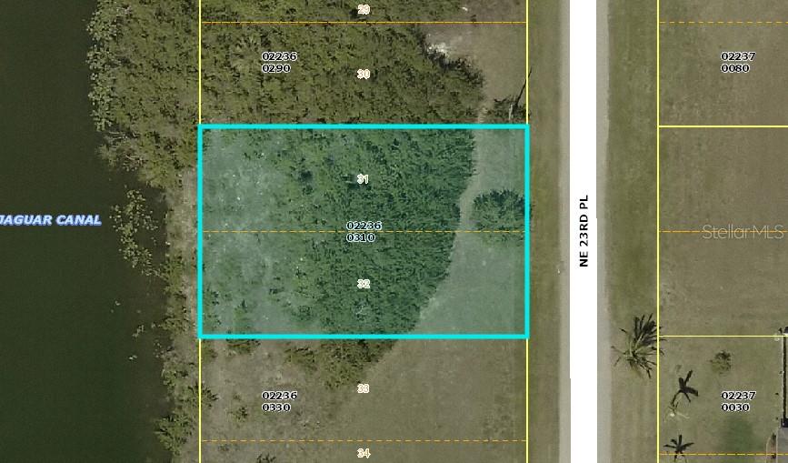 This is a map showing a vacant, rectangular waterfront lot highlighted in blue — 1916 NE 23RD PLACE, CAPE CORAL, FL