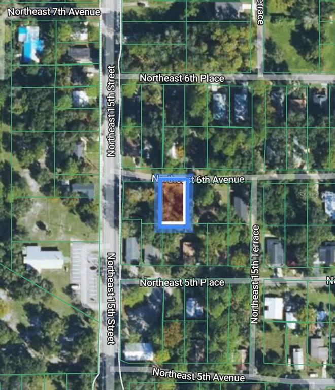 This is an aerial map showing a highlighted vacant residential lot in a suburban neighborhood — XX NE 6TH AVENUE, GAINESVILLE, FL