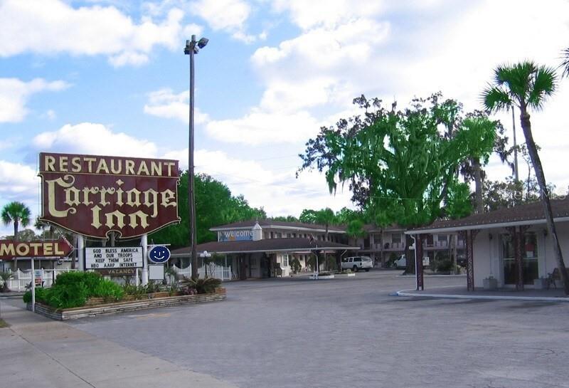 A view of the Carriage Inn motel exterior with a large sign and parking lot — 16872 SE HIGHWAY 19, CROSS CITY, FL