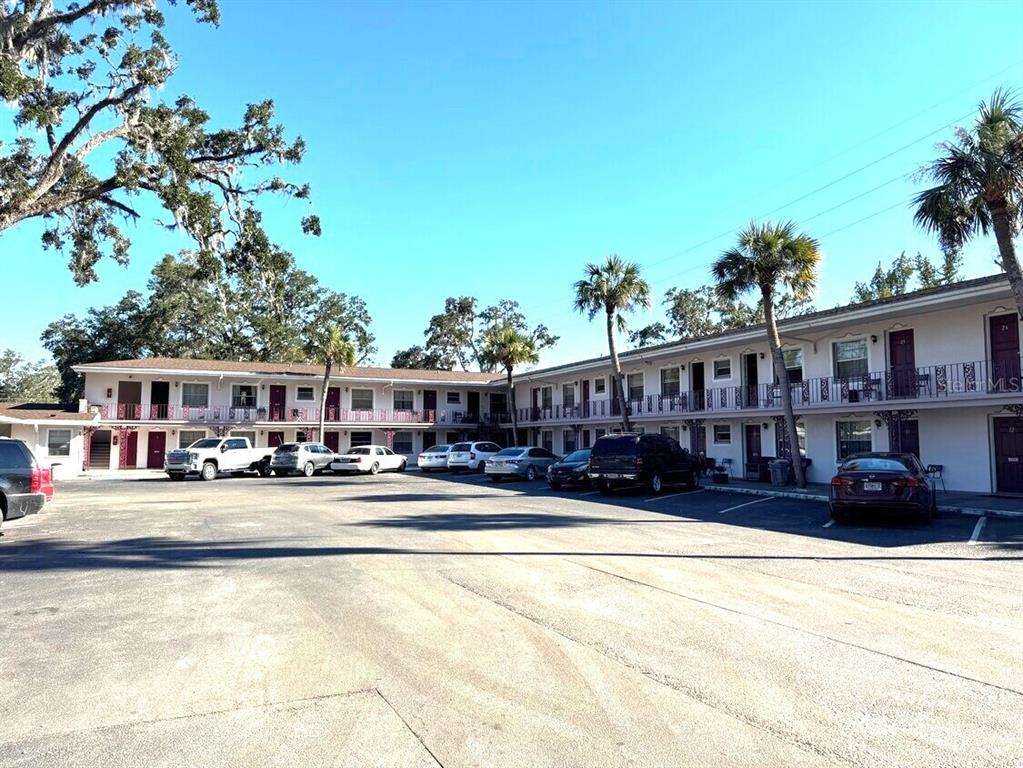 A two-story motel building with an outdoor parking lot and palm trees — 16872 SE HIGHWAY 19, CROSS CITY, FL