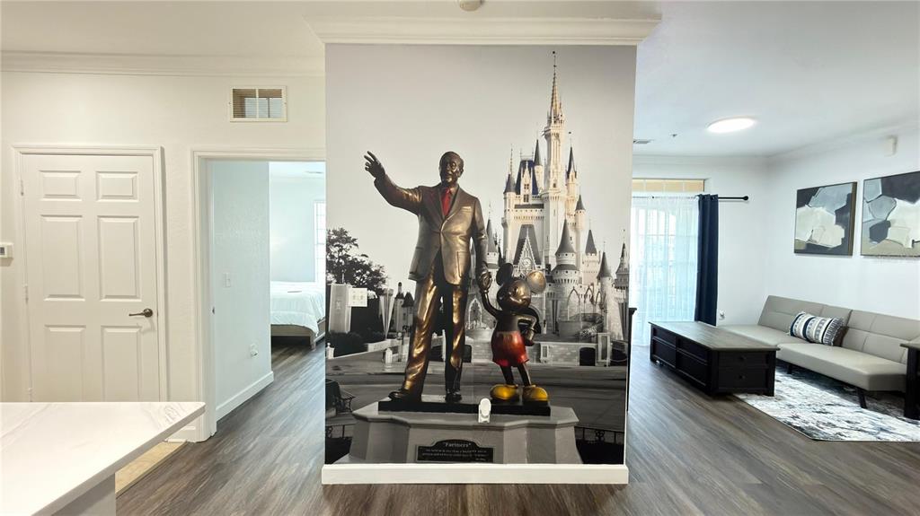 A living area features a large wall mural of the Partners statue and Cinderella Castle — 1301 TUSCAN TERRACE UNIT 9403, DAVENPORT, FL