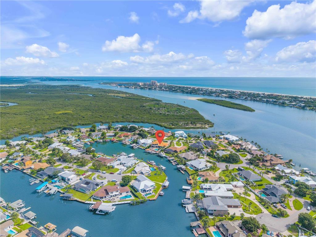 An aerial view shows a waterfront residential neighborhood with a red pin marking a house — 417 QUAY ASSISI, NEW SMYRNA BEACH, FL