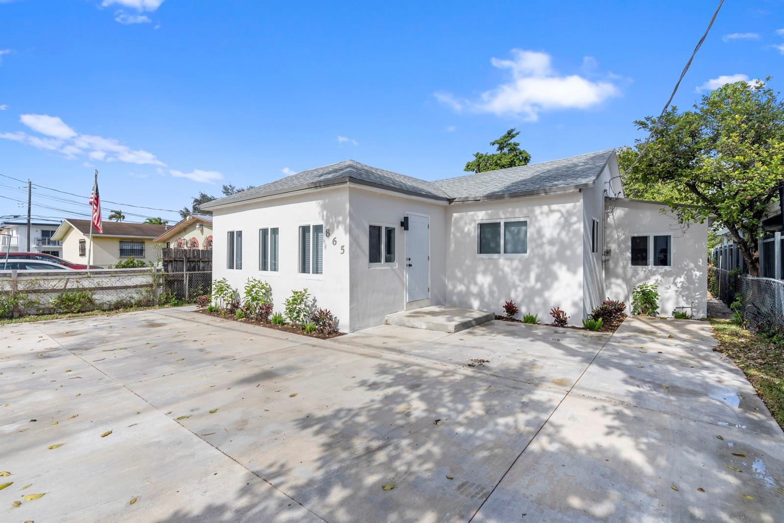 A white, single-story house with a concrete driveway and a small front yard — 865 SE 12th Street # A, Hialeah FL 33010, HIALEAH, FL