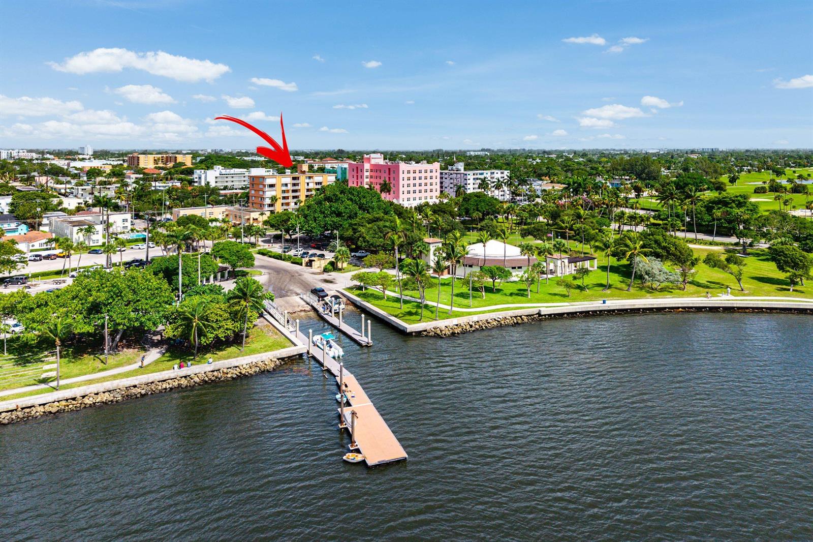 An aerial view shows a waterfront park with a pier and nearby apartment buildings — 15 S Golfview Road # 206, Lake Worth FL 33460, LAKE WORTH, FL
