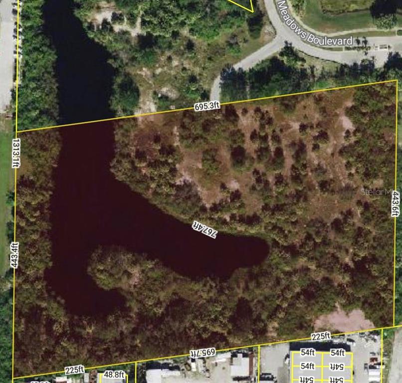 This is an aerial map showing a plot of land with a pond and dimensions — 4187 COUNTRY MEADOWS BOULEVARD, PUNTA GORDA, FL