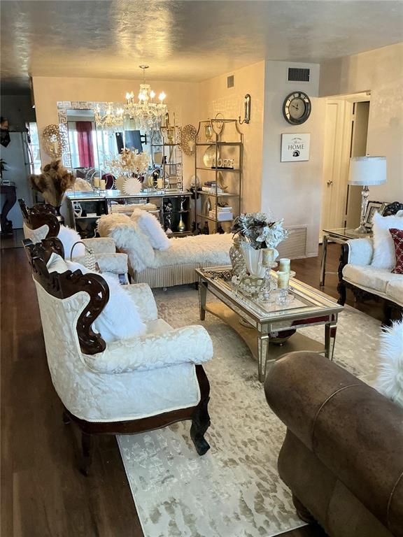 A living room features ornate white furniture, a mirrored coffee table, and a crystal chandelier — 4300 58TH STREET N UNIT 1909, KENNETH CITY, FL