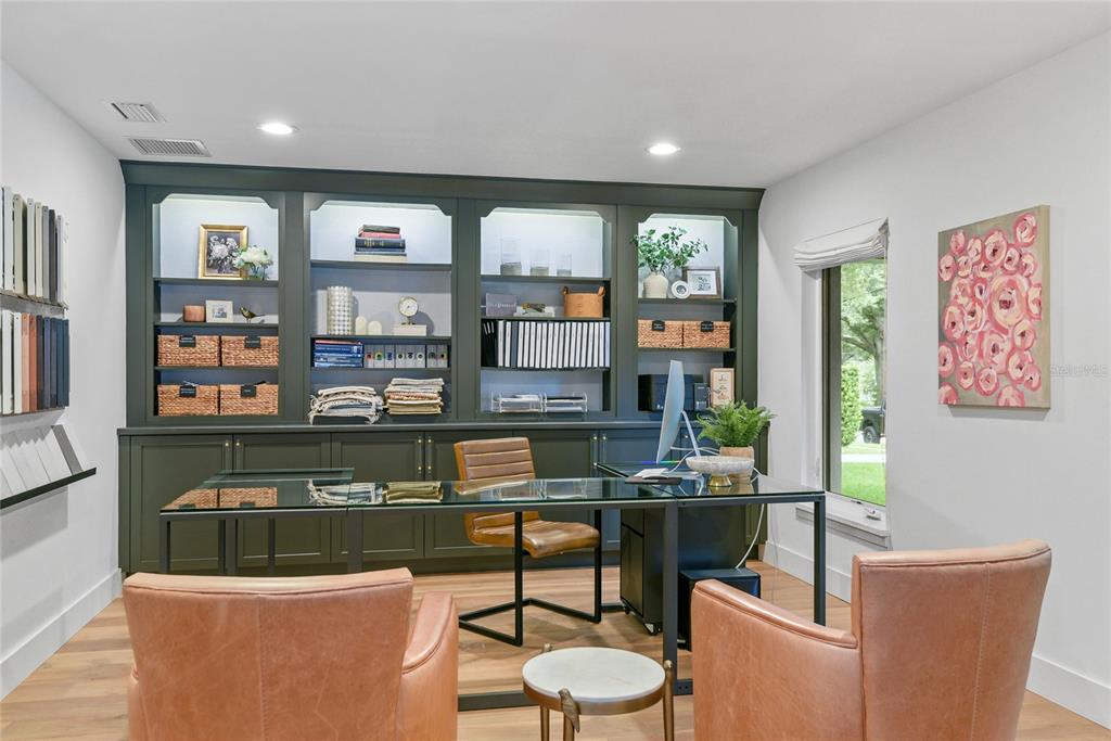A home office features dark green built-in shelving, a glass desk, and tan leather chairs — 220 ADAMS DRIVE, MAITLAND, FL