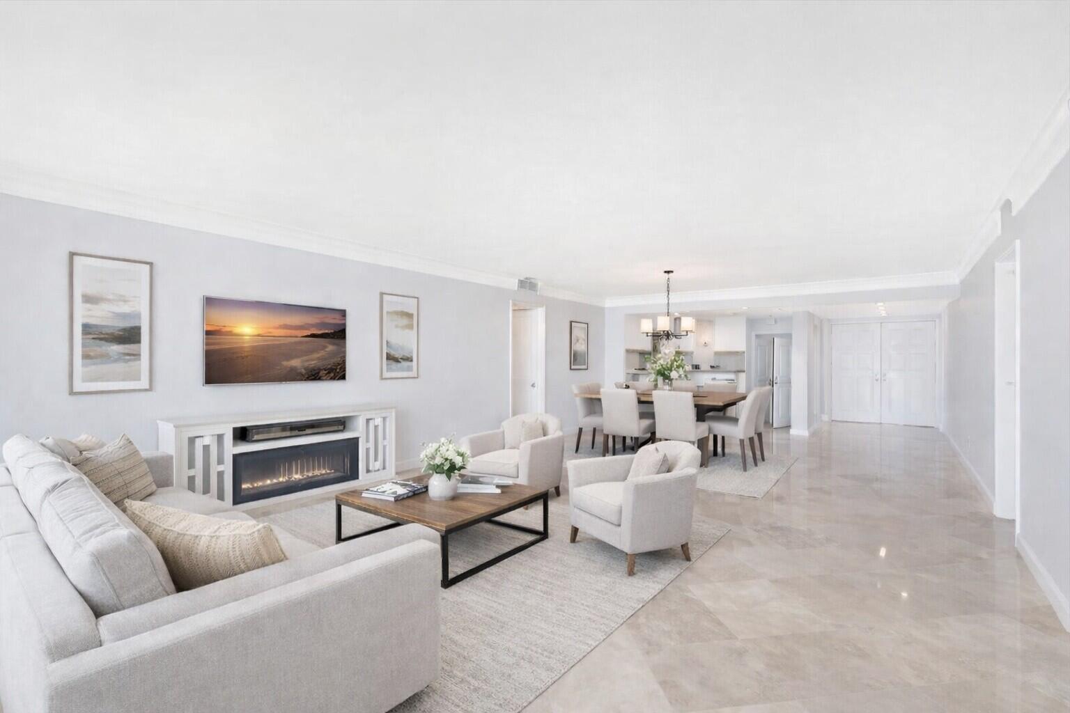 A bright, open-concept living and dining area features light-colored walls, tile flooring, and modern furniture — 400 Beach Road # 103, Tequesta FL 33469, TEQUESTA, FL
