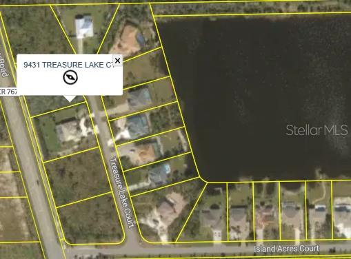 This is an aerial map view showing residential lots along a street and a lake — 9431 TREASURE LAKE COURT, ST JAMES CITY, FL