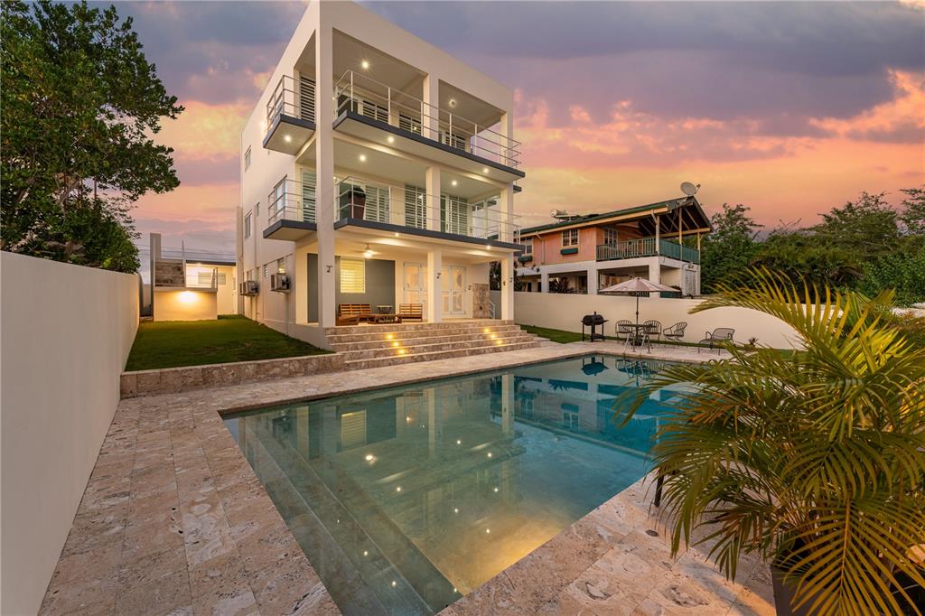 A three-story modern house with balconies overlooks a rectangular swimming pool and stone patio — SR 307 km 7.9 Boqueron VILLA NAUTICA, UNION ST, JOSE ST BEACH Lot # 2, BOQUERON, PR