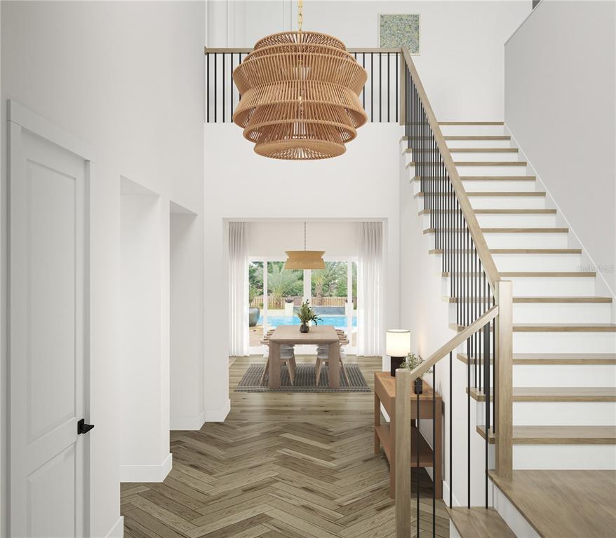This rendering shows an entryway with a staircase, herringbone wood floors, and a large chandelier — 3520 W PRICE AVENUE, TAMPA, FL