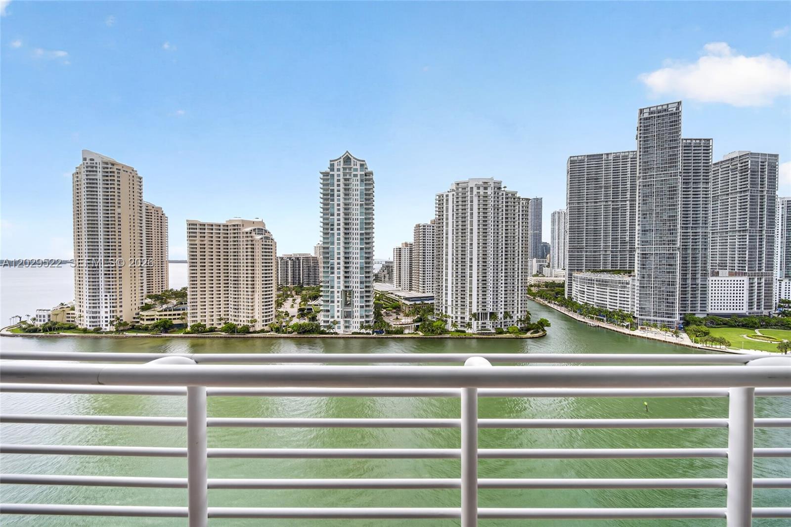 A balcony railing overlooks a body of water and a dense city skyline of skyscrapers — 325 S Biscayne Blvd # 2219, Miami FL 33131, MIAMI, FL