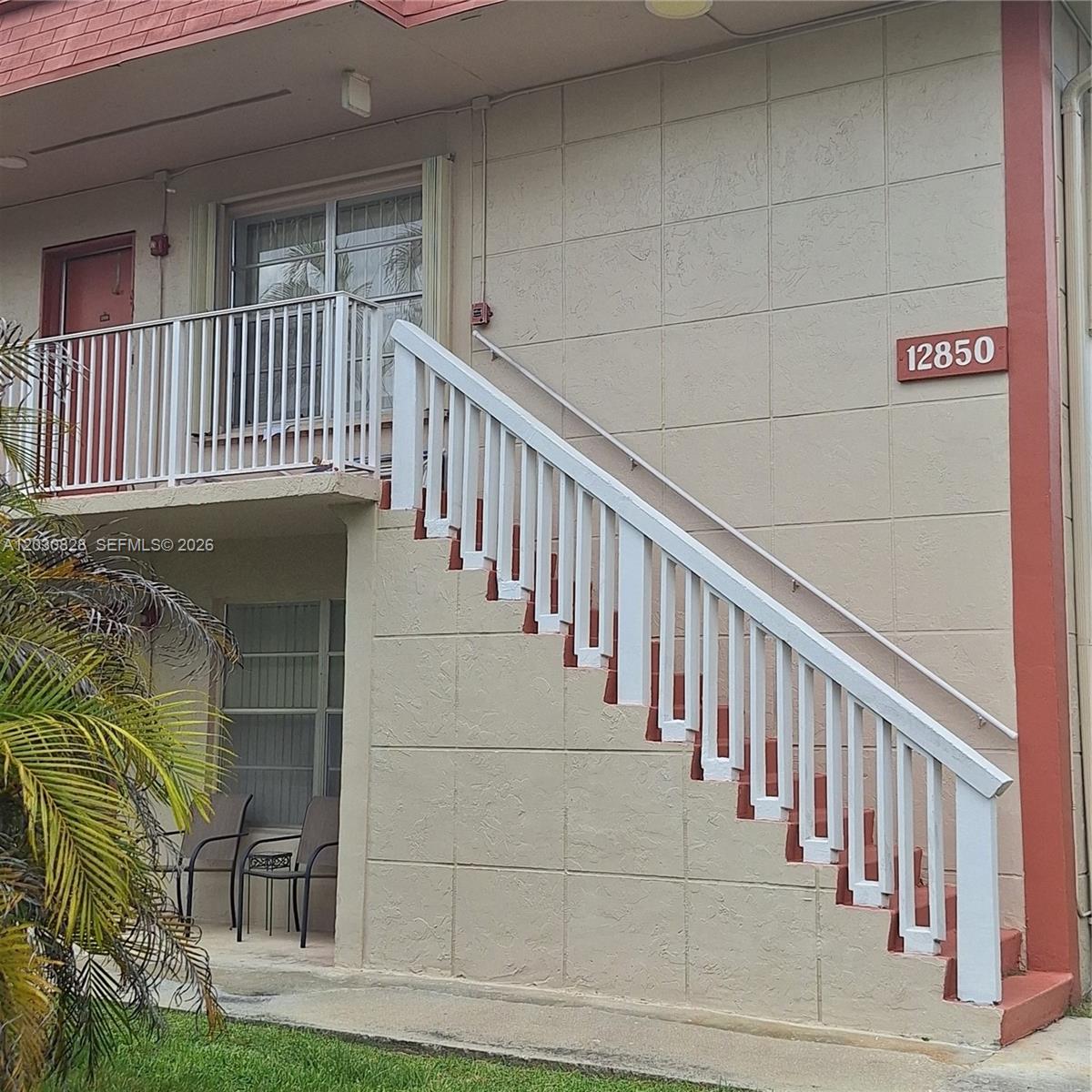 An exterior view shows a two-story building with a white staircase leading to a balcony — 12850 SW 43rd Dr # B, Miami FL 33175, MIAMI, FL