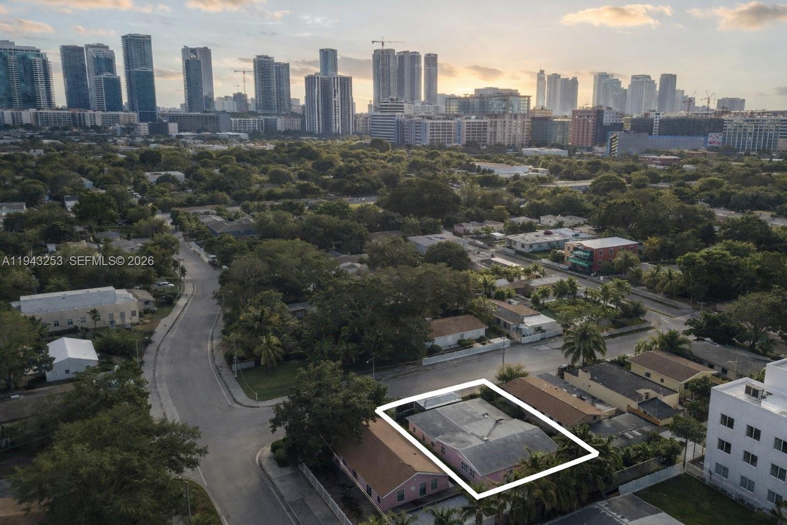 An aerial view shows a pink house highlighted by a white border in a neighborhood — 3240 NW 3rd Ave, Miami FL 33127, MIAMI, FL