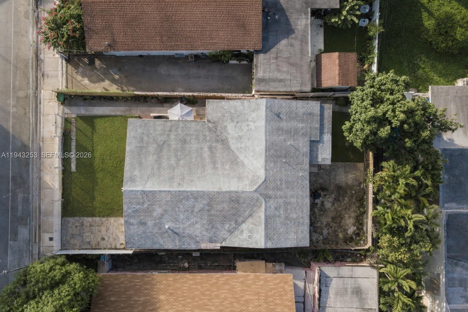 An aerial view shows a house with a gray roof, a front lawn, and backyard — 3240 NW 3rd Ave, Miami FL 33127, MIAMI, FL