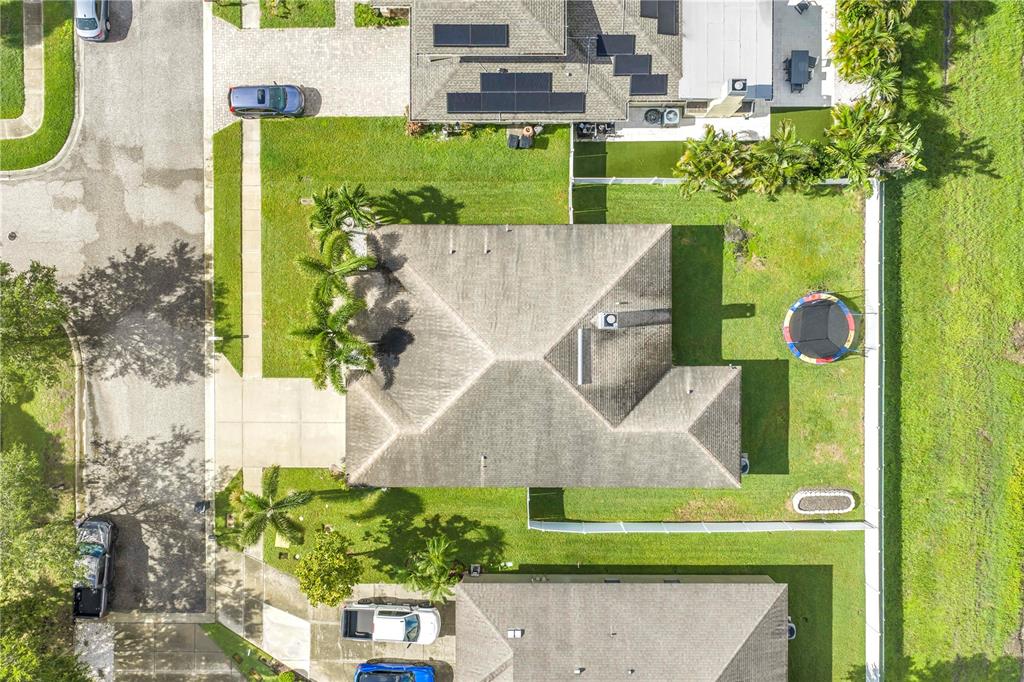 An aerial view shows a residential house with a gray roof, driveway, and backyard lawn — 6060 97TH AVENUE N, PINELLAS PARK, FL