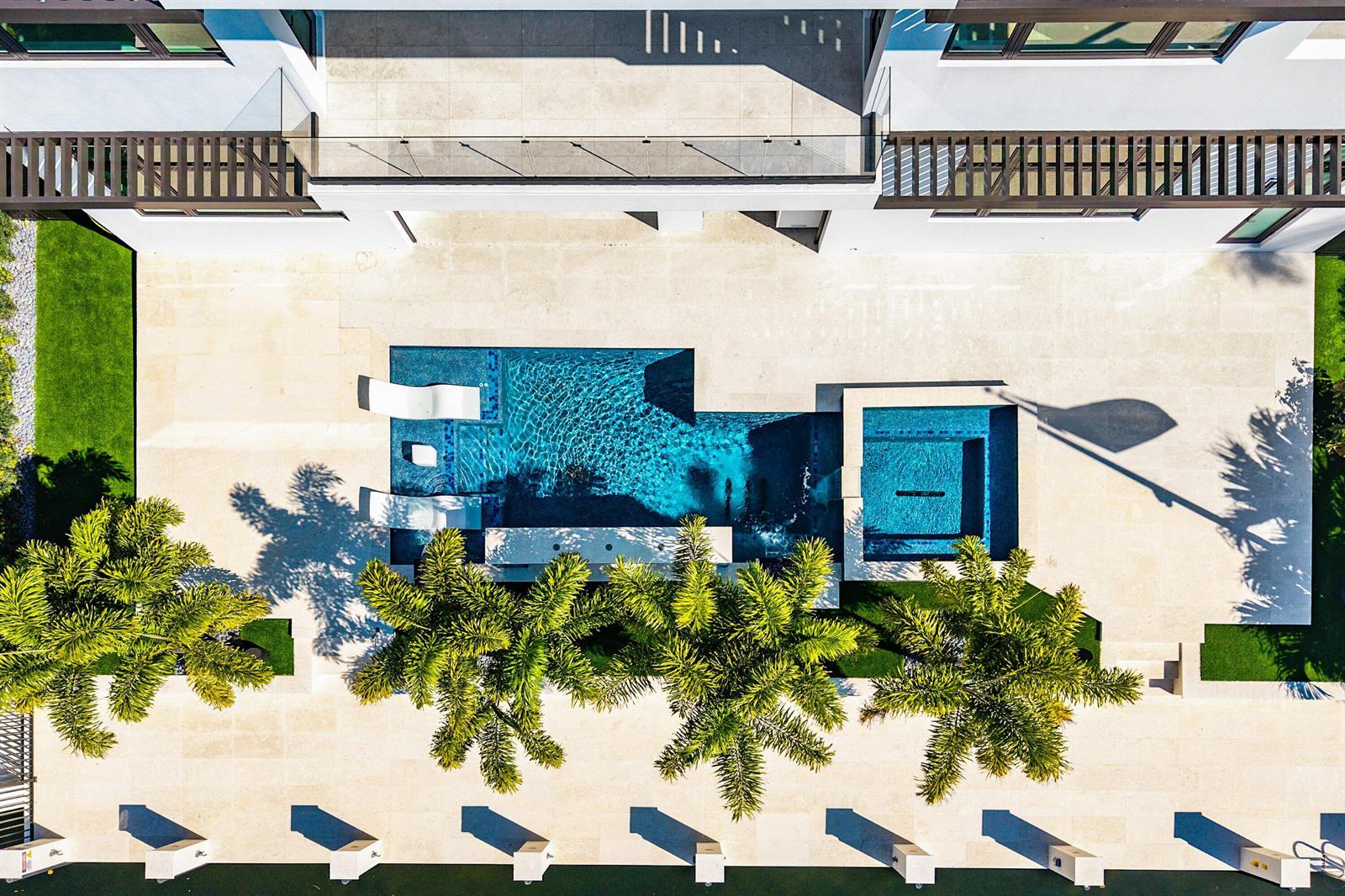 An aerial view shows a modern house with a pool, spa, and palm trees — 2650 NE 48th Court, Lighthouse Point FL 33064, LIGHTHOUSE POINT, FL