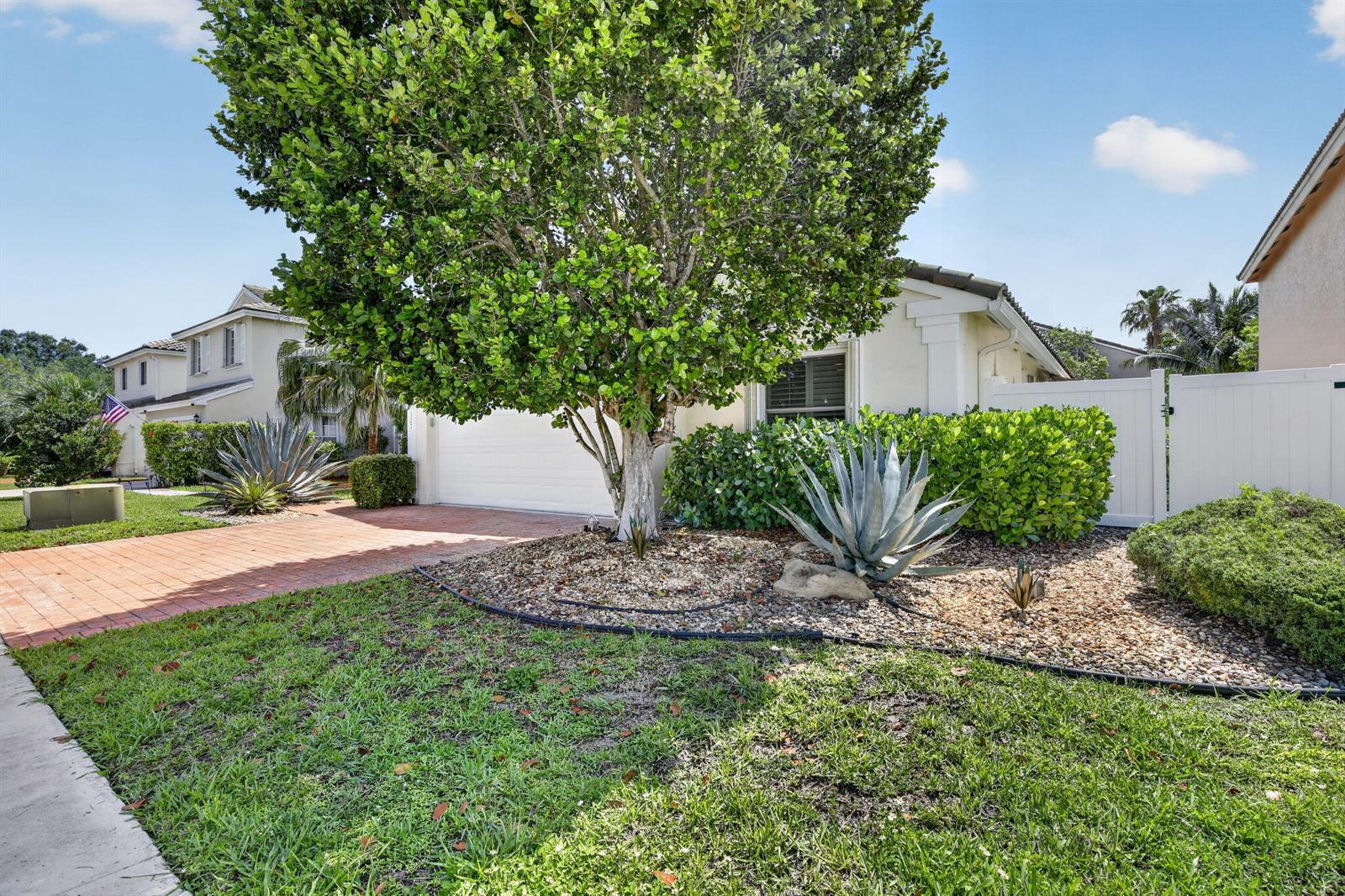 A front yard features a large tree, a brick driveway, and agave plants in landscaping — 327 SW 191st Terrace, Pembroke Pines FL 33029, PEMBROKE PINES, FL