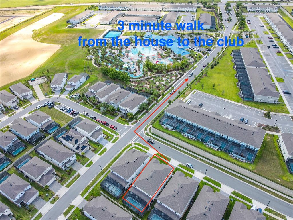 This aerial view shows a residential neighborhood with a highlighted path to a community clubhouse — 1978 SUMMER DRIVE, DAVENPORT, FL