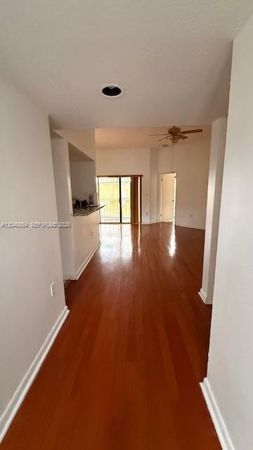 A view from a hallway looking into an open living area with hardwood floors — 9691 SW 138th Ave, Miami FL 33186, MIAMI, FL