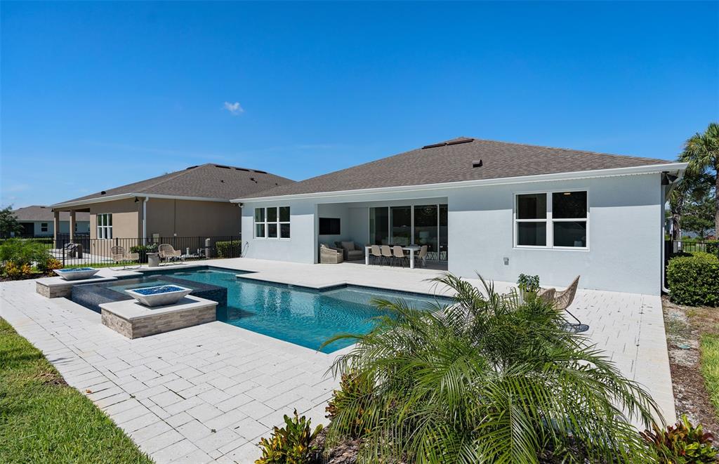 The backyard features a swimming pool with a spa and a paved patio area — 6213 CITRUS GROVE COURT, ST CLOUD, FL