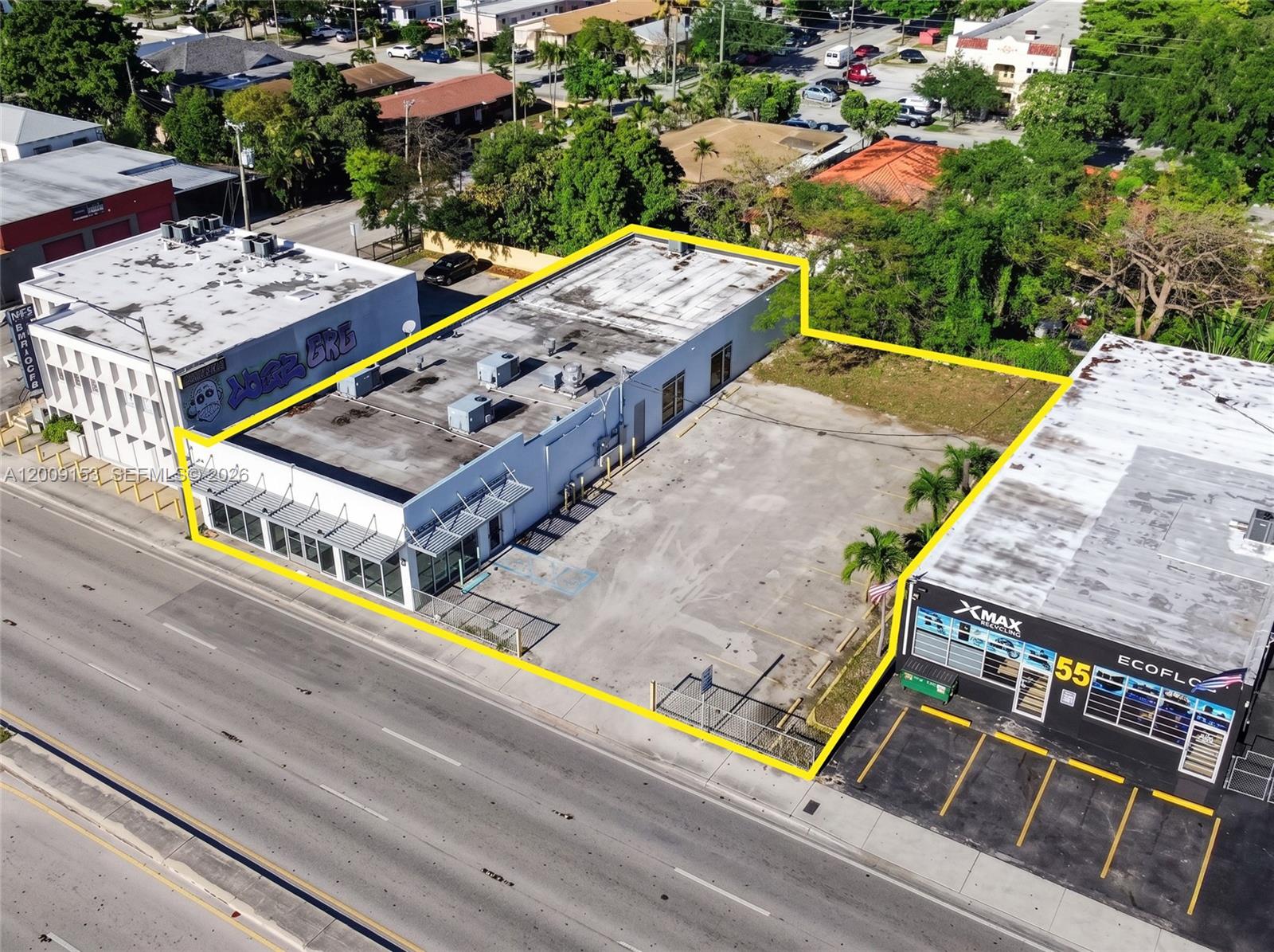 An aerial view shows a commercial building with a parking lot outlined in yellow — 69 NW 27th Ave, Miami FL 33125, MIAMI, FL