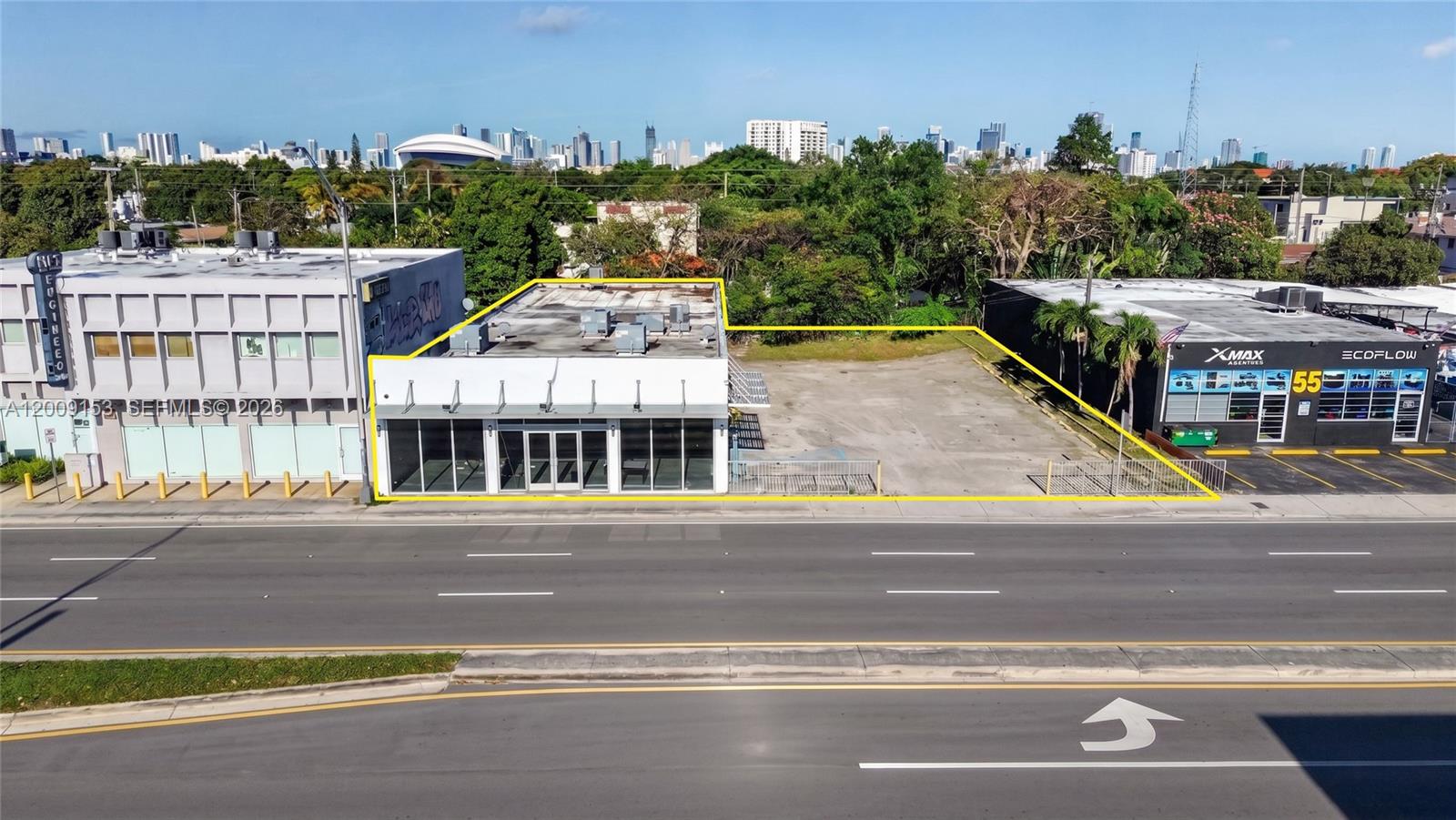 An aerial view shows a commercial building with an adjacent paved lot along a road — 69 NW 27th Ave, Miami FL 33125, MIAMI, FL